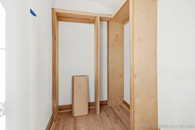 interior space with hardwood / wood-style floors and lofted ceiling