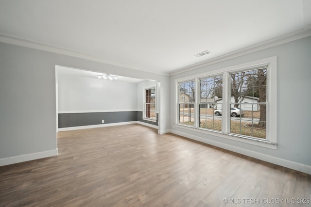 unfurnished room featuring crown molding and wood-type flooring