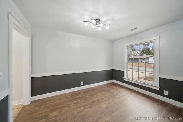 unfurnished room with hardwood / wood-style flooring