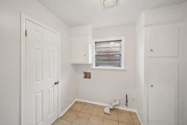 laundry room with washer hookup, cabinets, and light tile patterned flooring