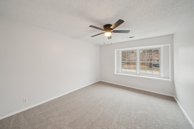 unfurnished room featuring carpet floors, ceiling fan, and a textured ceiling