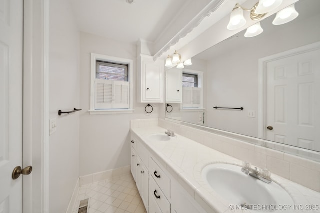 bathroom with a wealth of natural light, tile patterned floors, and vanity