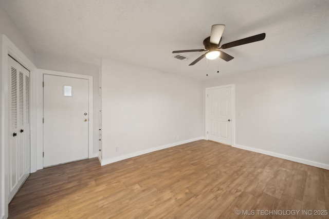 unfurnished room featuring ceiling fan and wood-type flooring