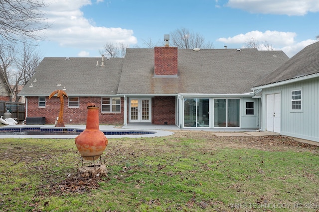 rear view of property with a yard and a patio