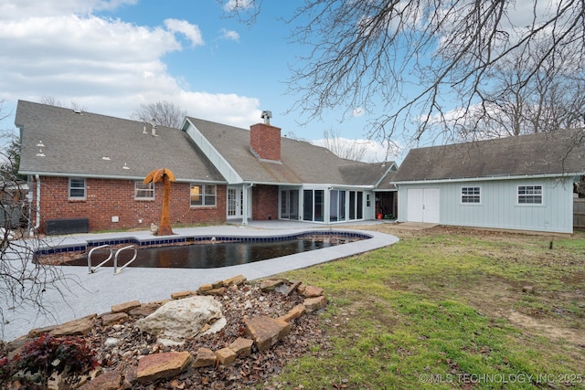 rear view of house featuring a patio area and a lawn