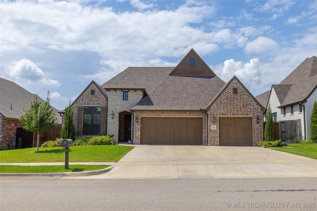 view of front of house featuring a garage and a front lawn