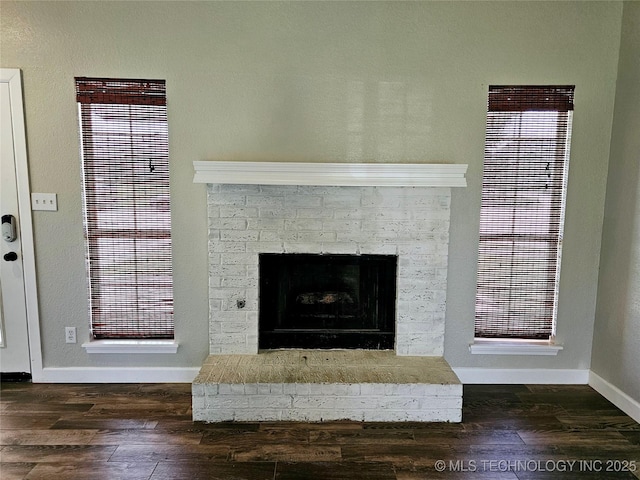 room details featuring a brick fireplace and hardwood / wood-style floors