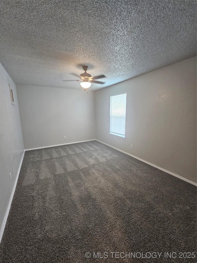 carpeted spare room featuring a textured ceiling and ceiling fan