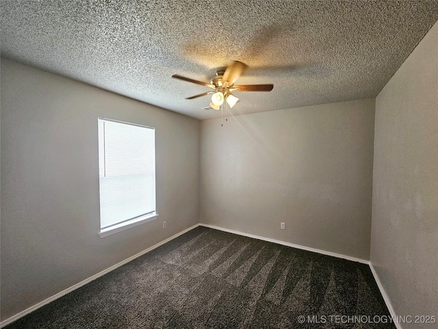 empty room with ceiling fan and dark carpet