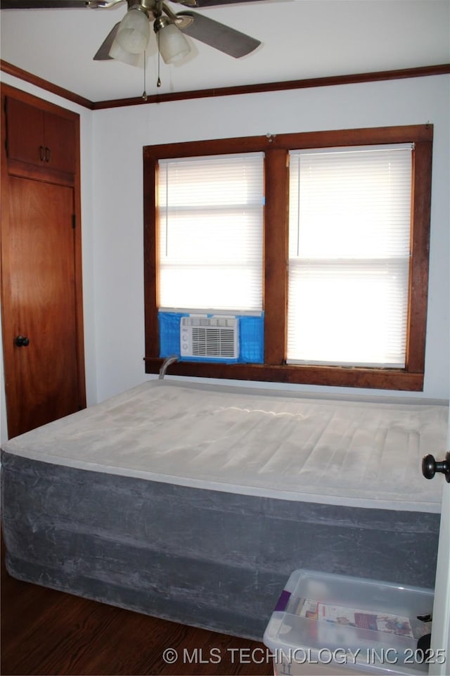 bedroom featuring ceiling fan, cooling unit, and hardwood / wood-style floors