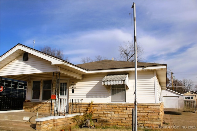 view of front of house with an outdoor structure and a garage