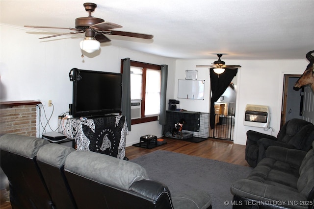 living room featuring heating unit, ceiling fan, and dark hardwood / wood-style flooring