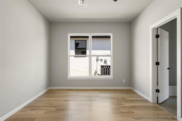 spare room with light hardwood / wood-style flooring