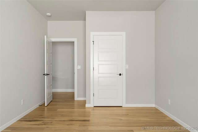 unfurnished bedroom with light wood-type flooring