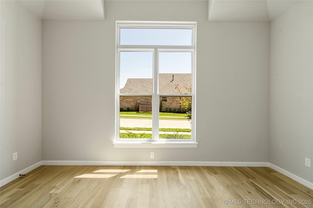 spare room with light hardwood / wood-style floors and a healthy amount of sunlight