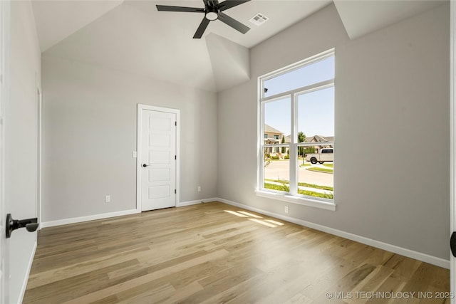 spare room with ceiling fan, lofted ceiling, and light hardwood / wood-style flooring