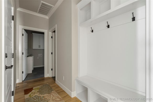 mudroom with wood-type flooring