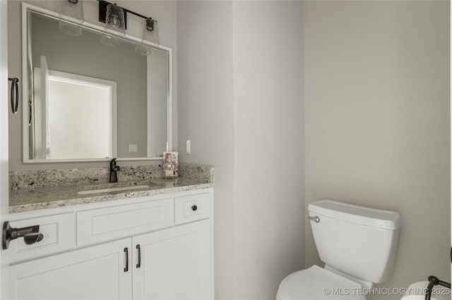 bathroom with toilet and vanity