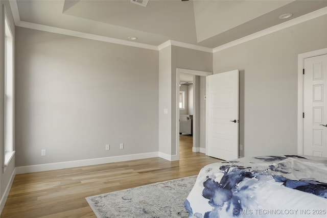 bedroom featuring light hardwood / wood-style floors and a towering ceiling