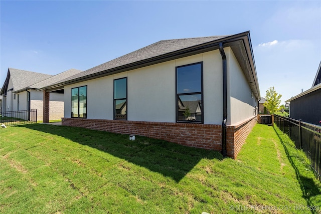 rear view of property featuring central AC unit and a yard