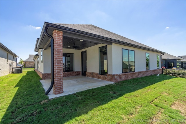 back of property featuring ceiling fan, central AC, a lawn, and a patio