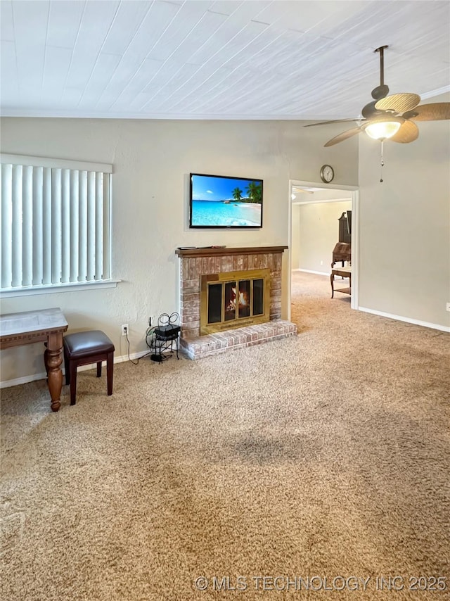 living room featuring ceiling fan, carpet, a fireplace, and wooden ceiling