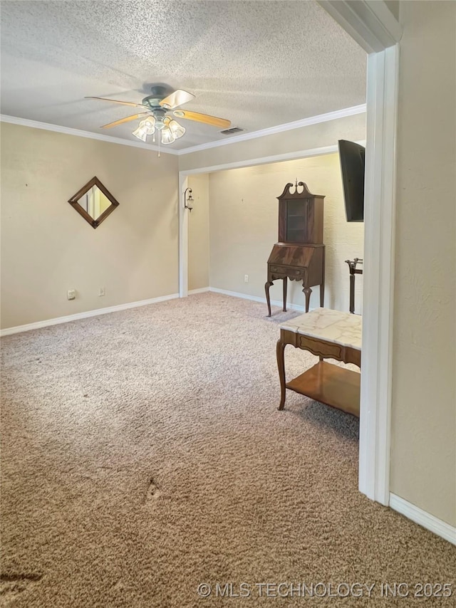 sitting room with ceiling fan, carpet, crown molding, and a textured ceiling