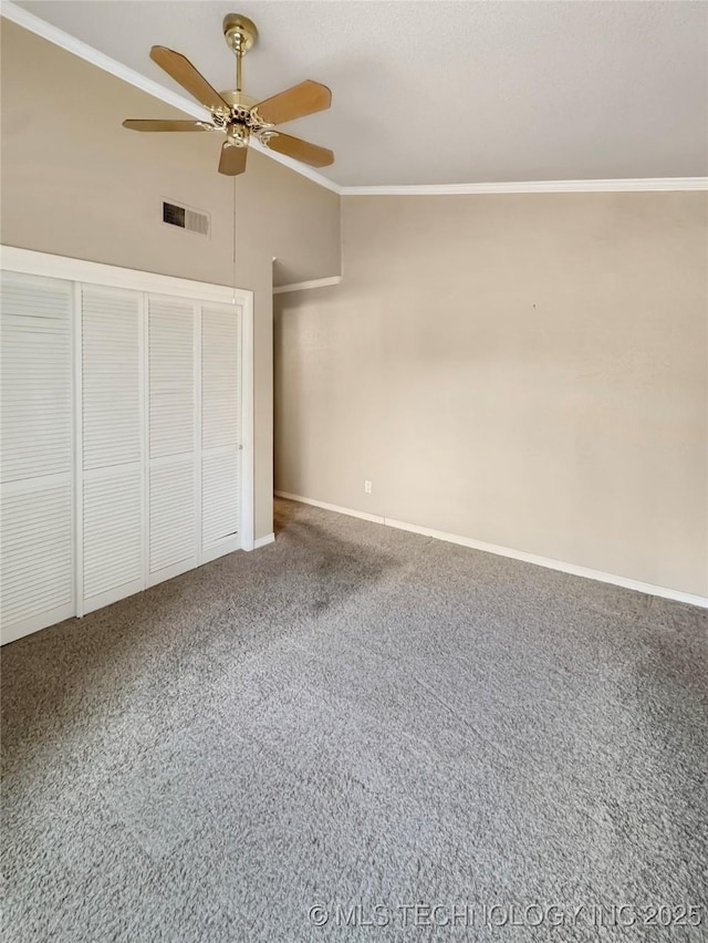 unfurnished bedroom with lofted ceiling, ceiling fan, crown molding, and carpet floors