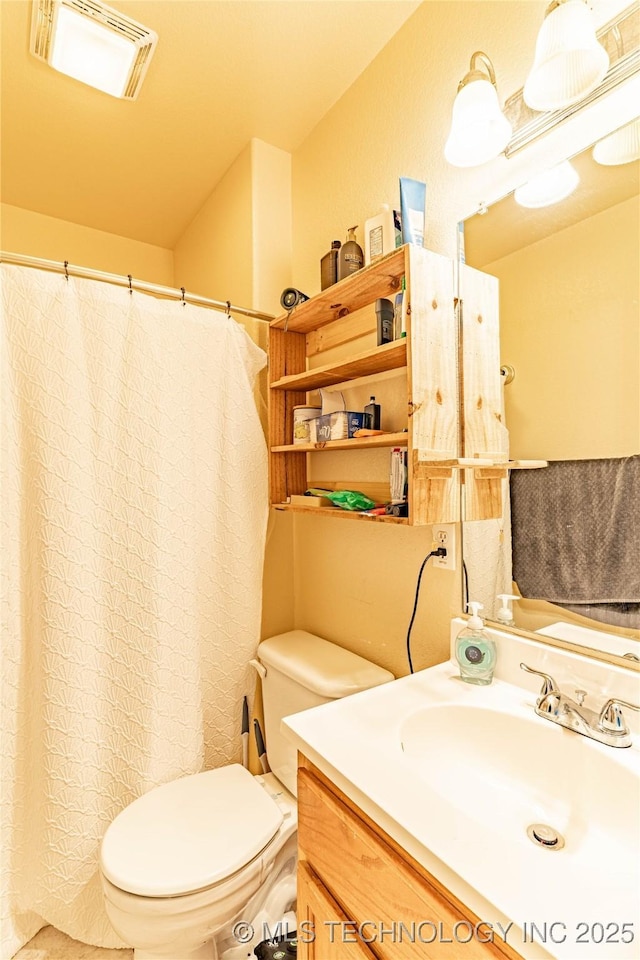 bathroom featuring toilet and vanity