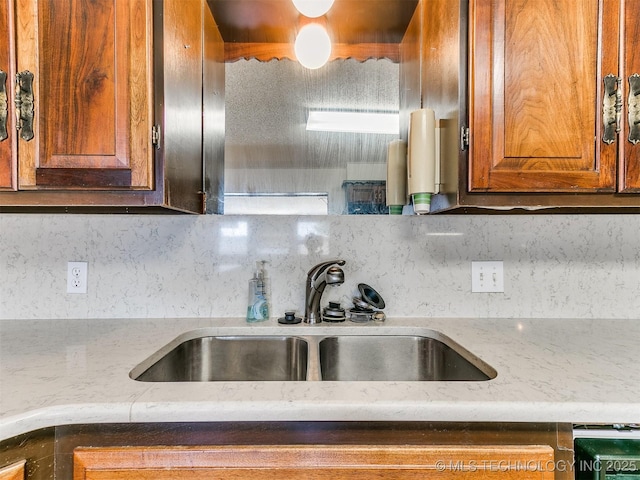 kitchen featuring backsplash and sink