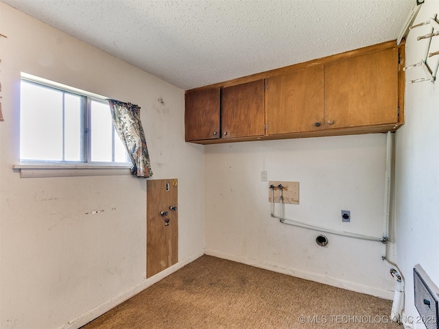 laundry room featuring light carpet, hookup for an electric dryer, hookup for a washing machine, a textured ceiling, and cabinets