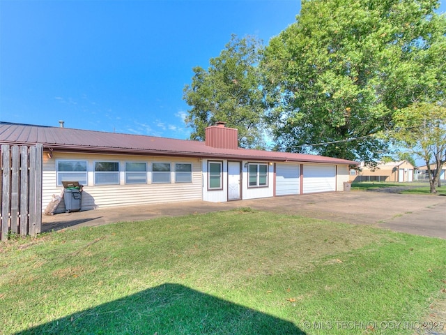 single story home featuring a garage and a front lawn