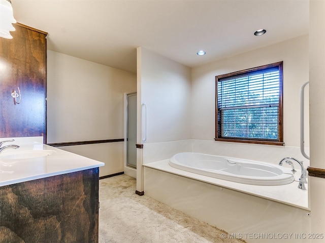 bathroom featuring plus walk in shower and vanity