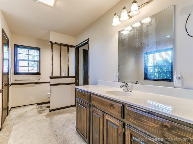 bathroom featuring toilet and vanity