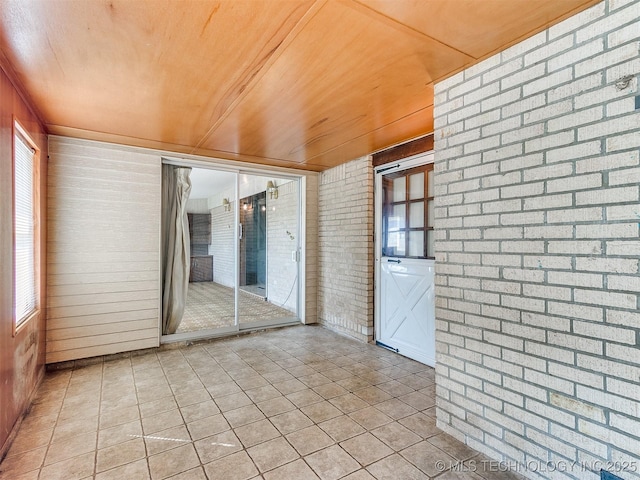 unfurnished sunroom with wood ceiling