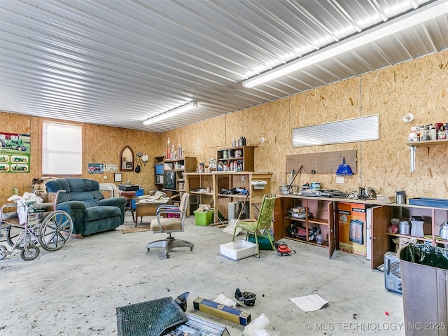 miscellaneous room with a workshop area and concrete flooring