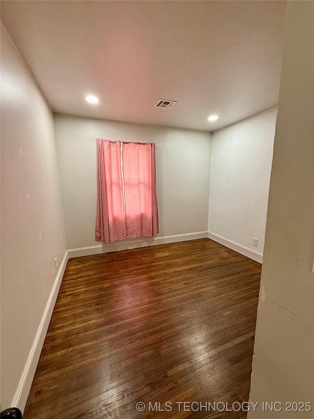 unfurnished room with dark wood-type flooring