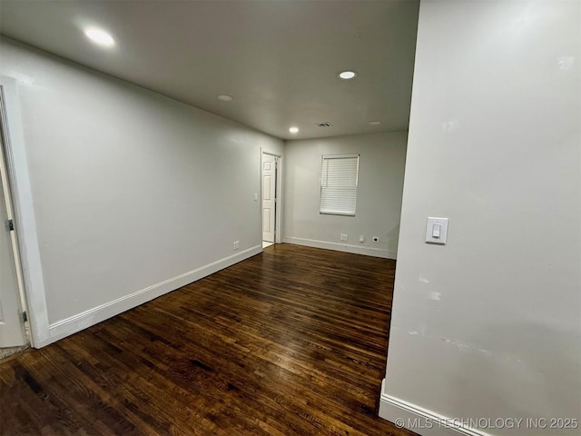 unfurnished room with dark hardwood / wood-style floors