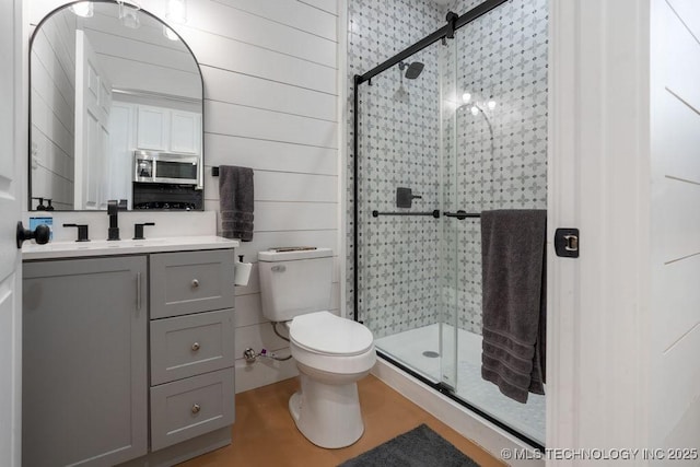 bathroom with vanity, wooden walls, and a shower with door