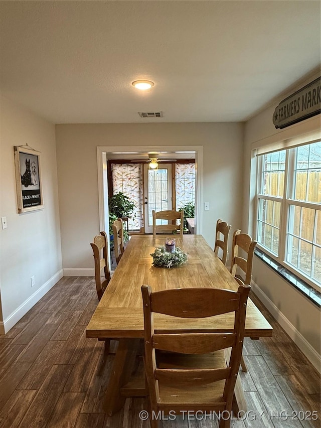 dining space with plenty of natural light and dark hardwood / wood-style flooring