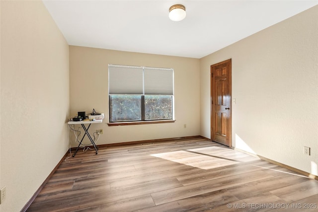 unfurnished room featuring wood-type flooring