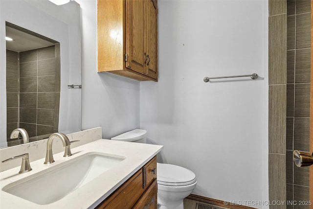 bathroom with toilet and vanity