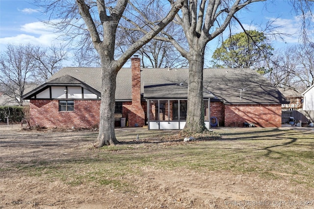 view of front of house with a sunroom and a front lawn