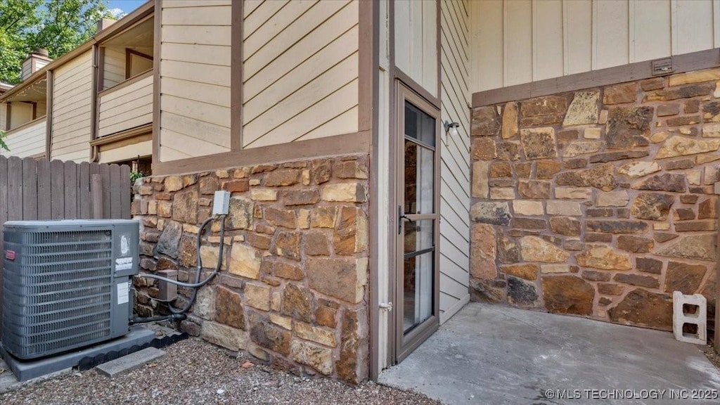 view of side of property featuring central AC