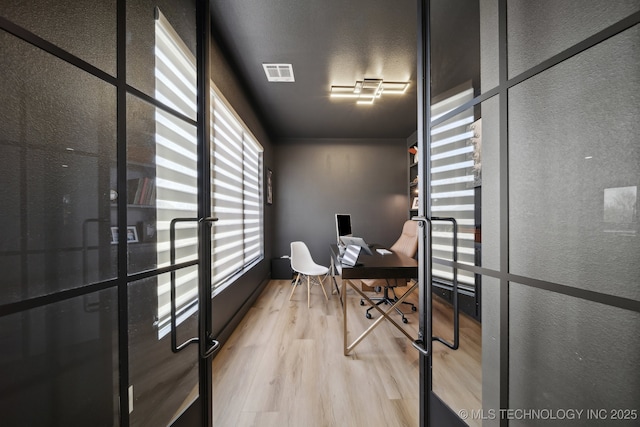 office space with light wood-type flooring