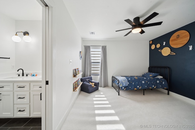 bedroom with ceiling fan, carpet, and sink