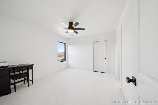 spare room with ceiling fan and light colored carpet