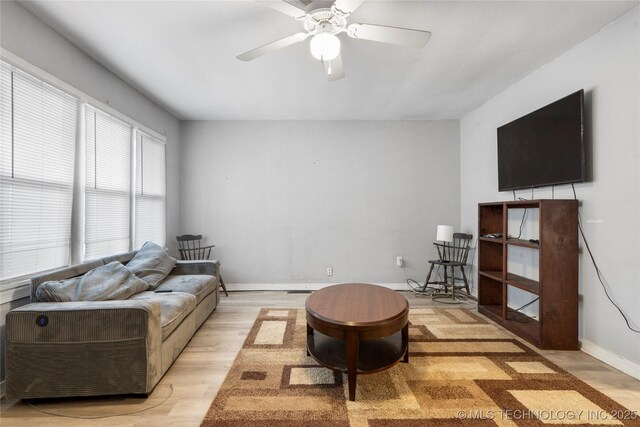 living room featuring ceiling fan and light hardwood / wood-style floors