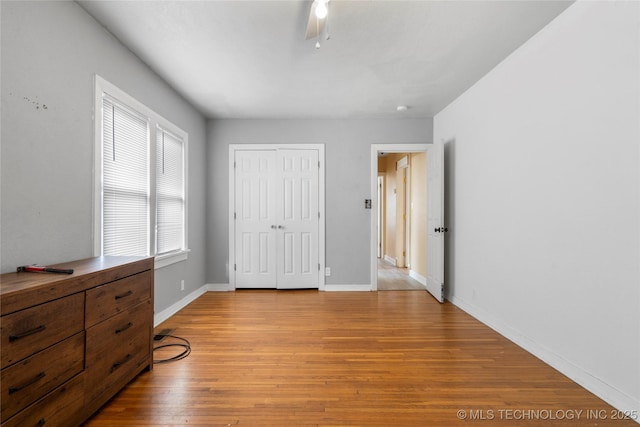 bedroom with ceiling fan, a closet, and light hardwood / wood-style floors