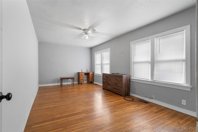 spare room featuring ceiling fan and hardwood / wood-style flooring